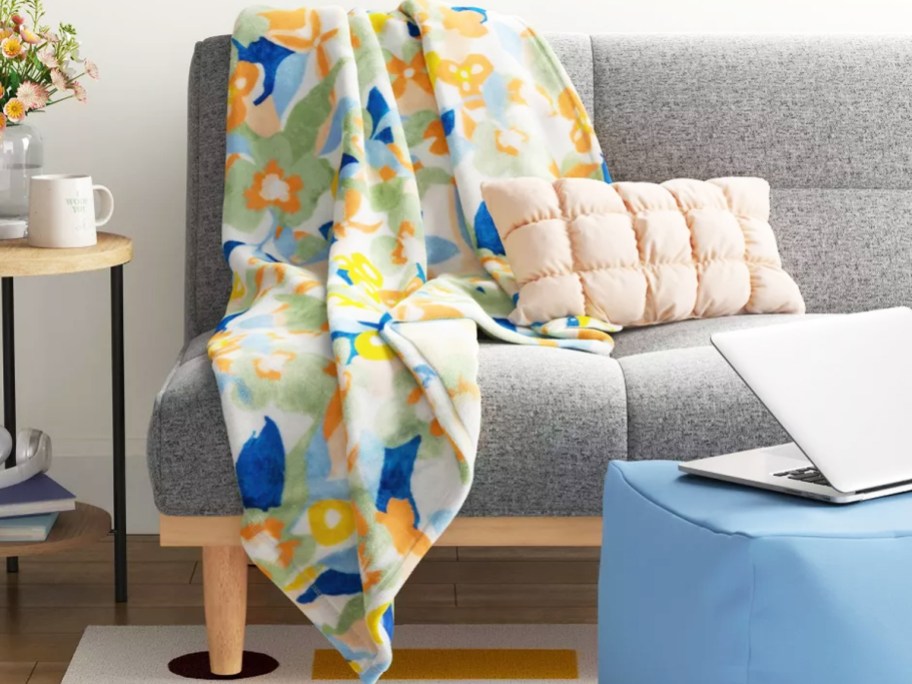 floral print throw blanket draped over couch