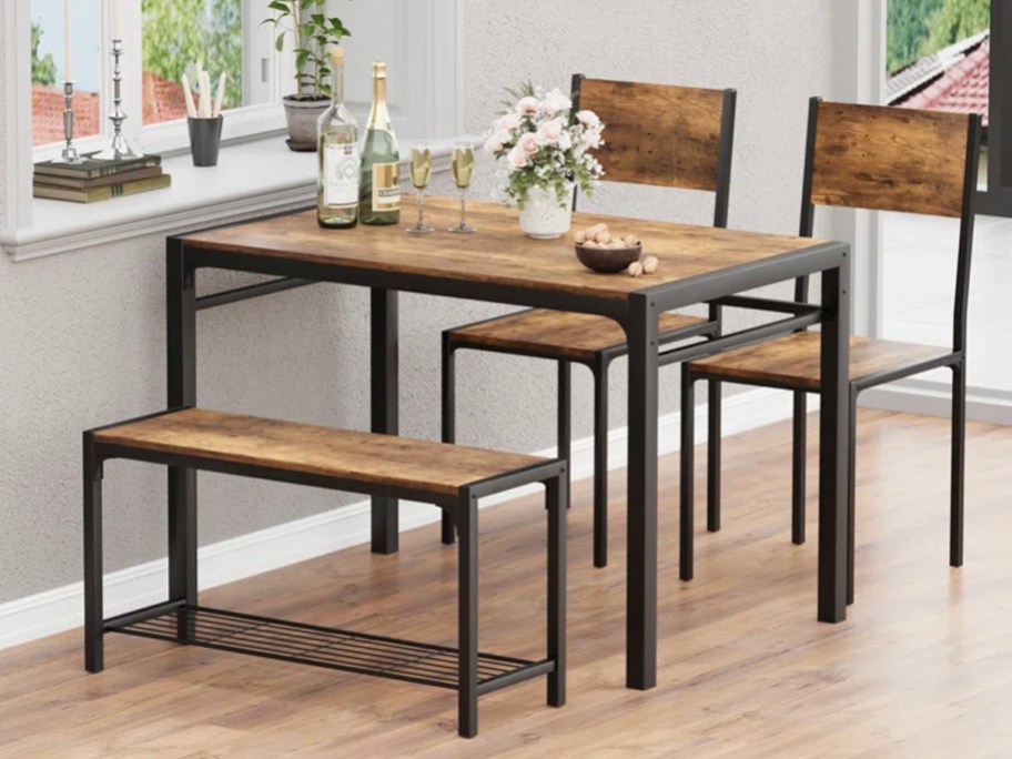 wood and black dining set with two chairs and bench
