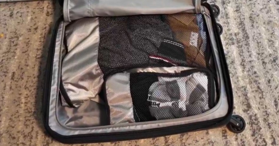 travel cubes in a suitcase on a the floor