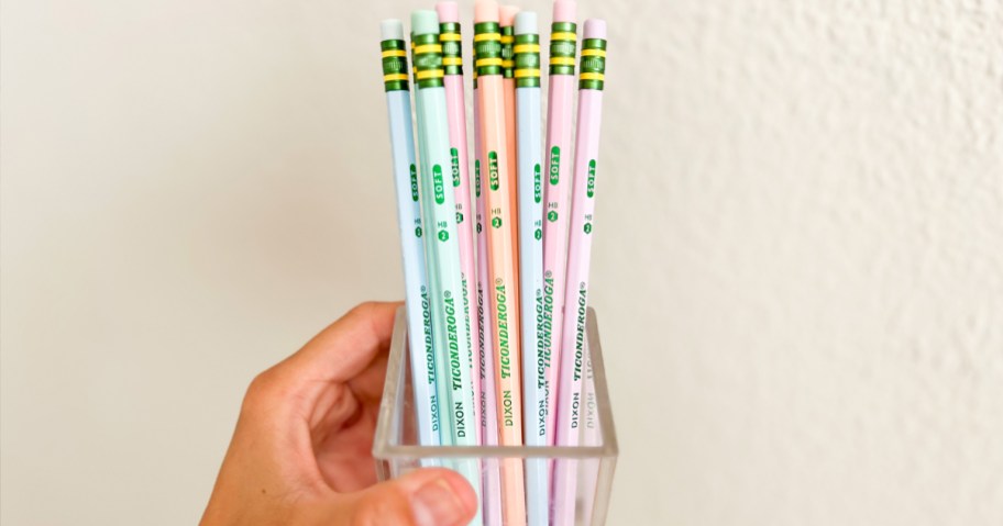 hand holding a glass jar full of Ticonderoga Pastel Pencils