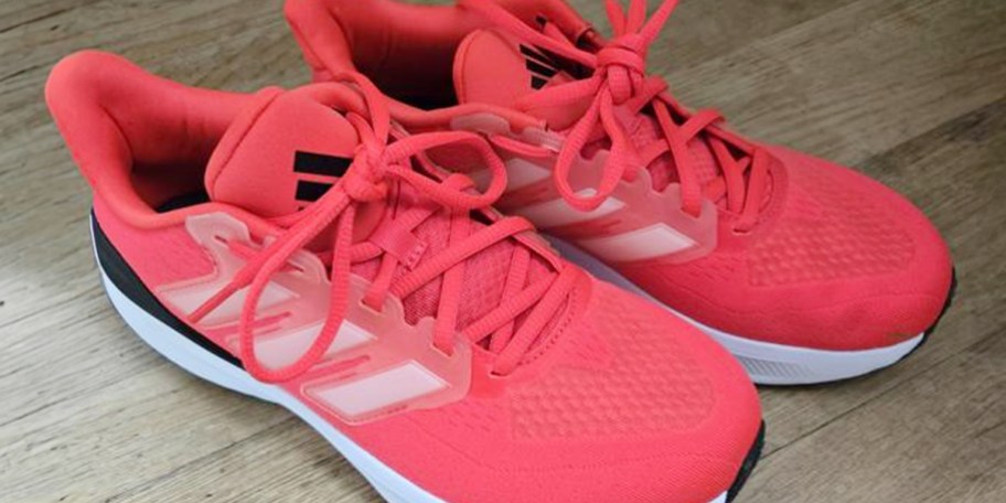 pair of red and white adidas shoes