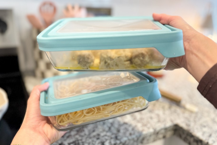 two Anchor Hocking TrueSeal Rectangle Glass Containers in hand