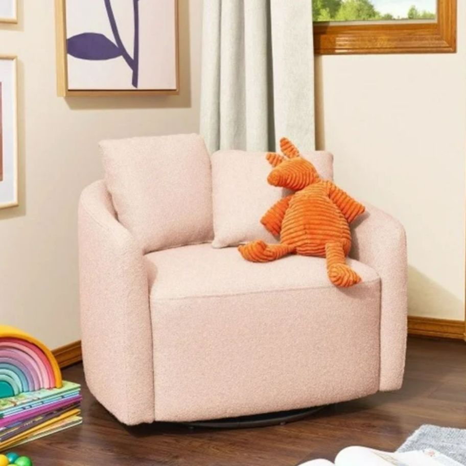 a pink boucle kids swivel chair